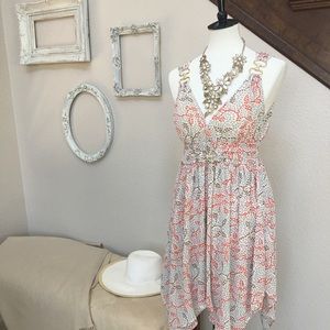 Sleeveless dress with gold jewelry accents